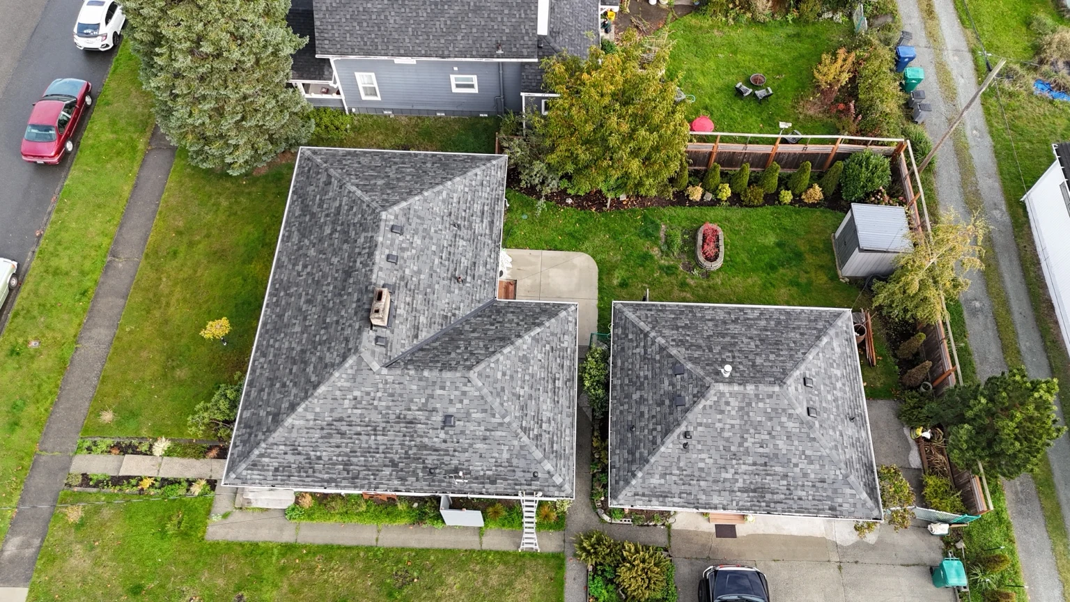 Overhead view of Storm Grey shingle roofs on the home and smaller building in Anacortes, Washington