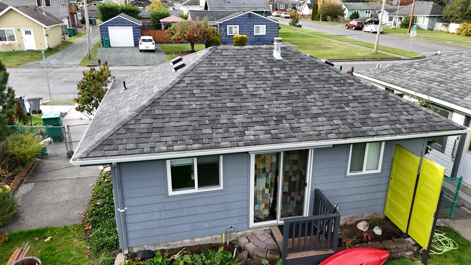 Close aerial view showing the texture and gray tones of Malarkey Highlander shingles on a hip roof