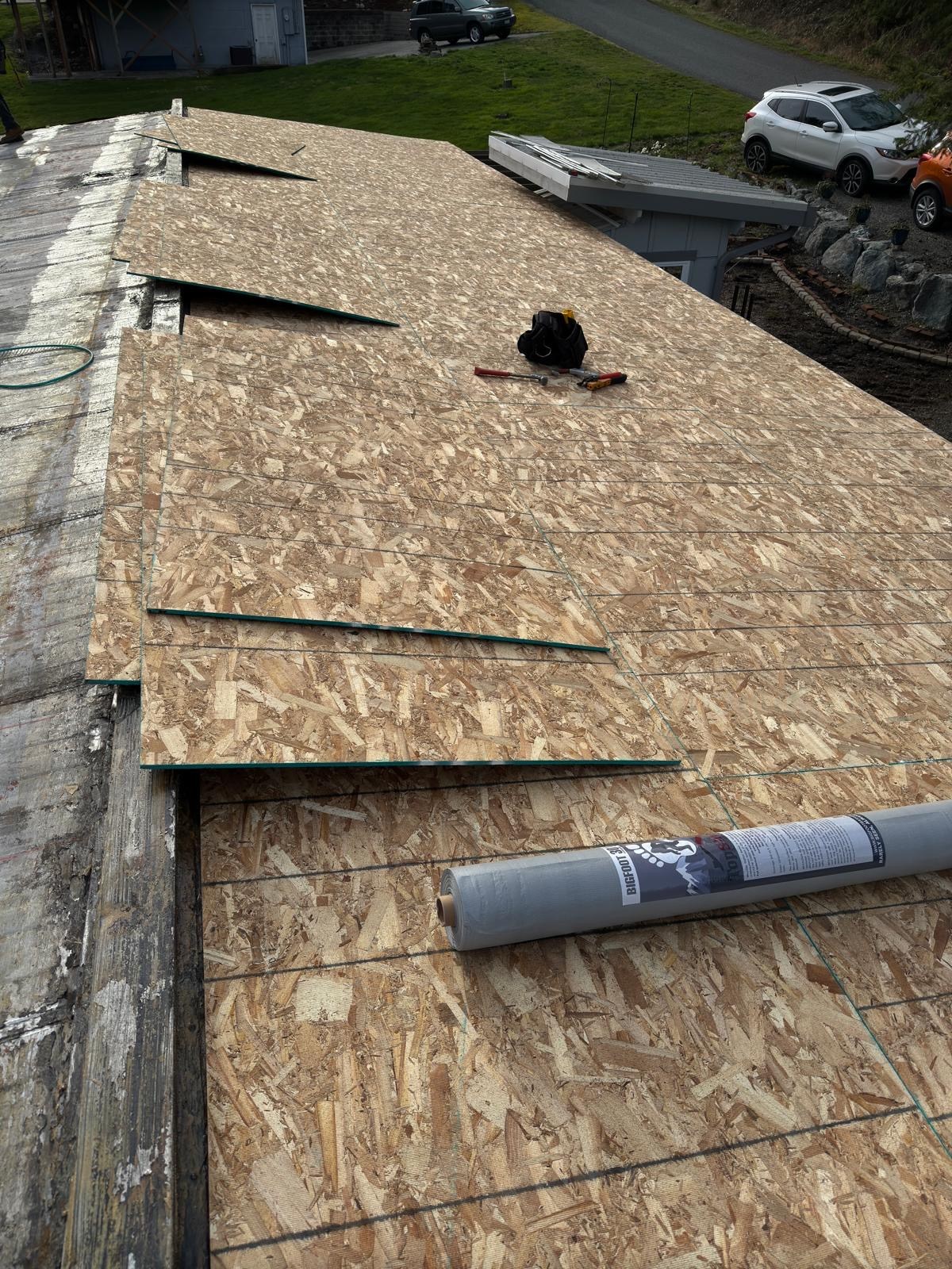 New roof decking panels being fitted across the low-slope roof