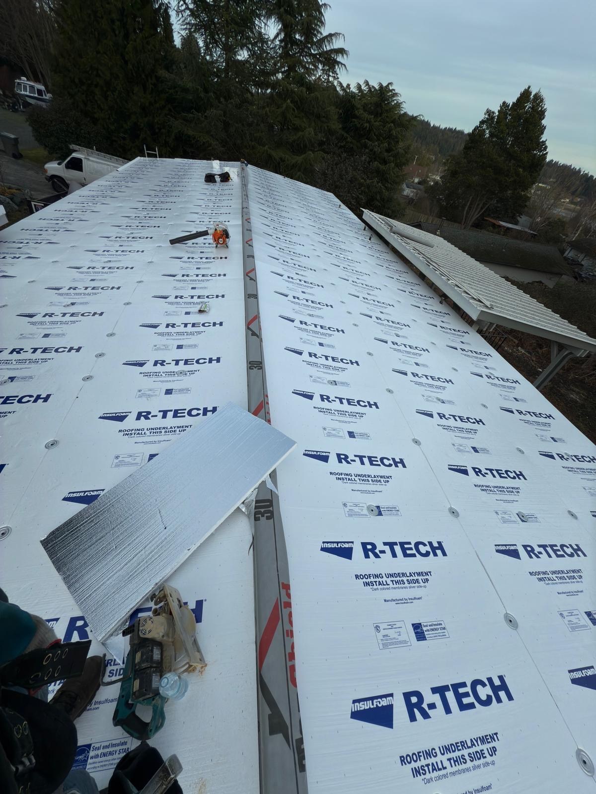 Fan-fold insulation secured across the roof before the white PVC membrane was installed