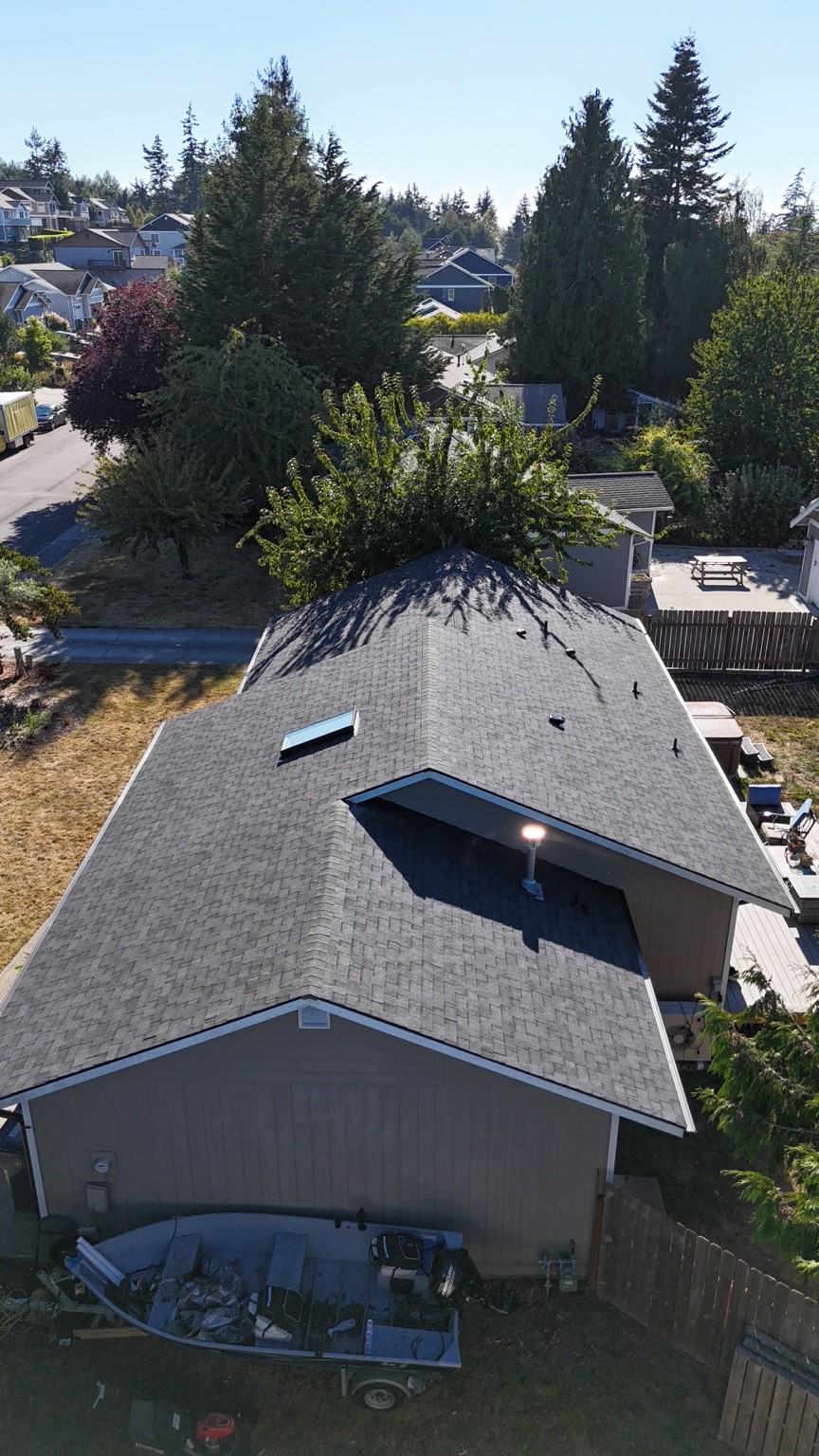 Aerial view along the Anacortes home’s shingle roof, including the skylight and intersecting roof planes