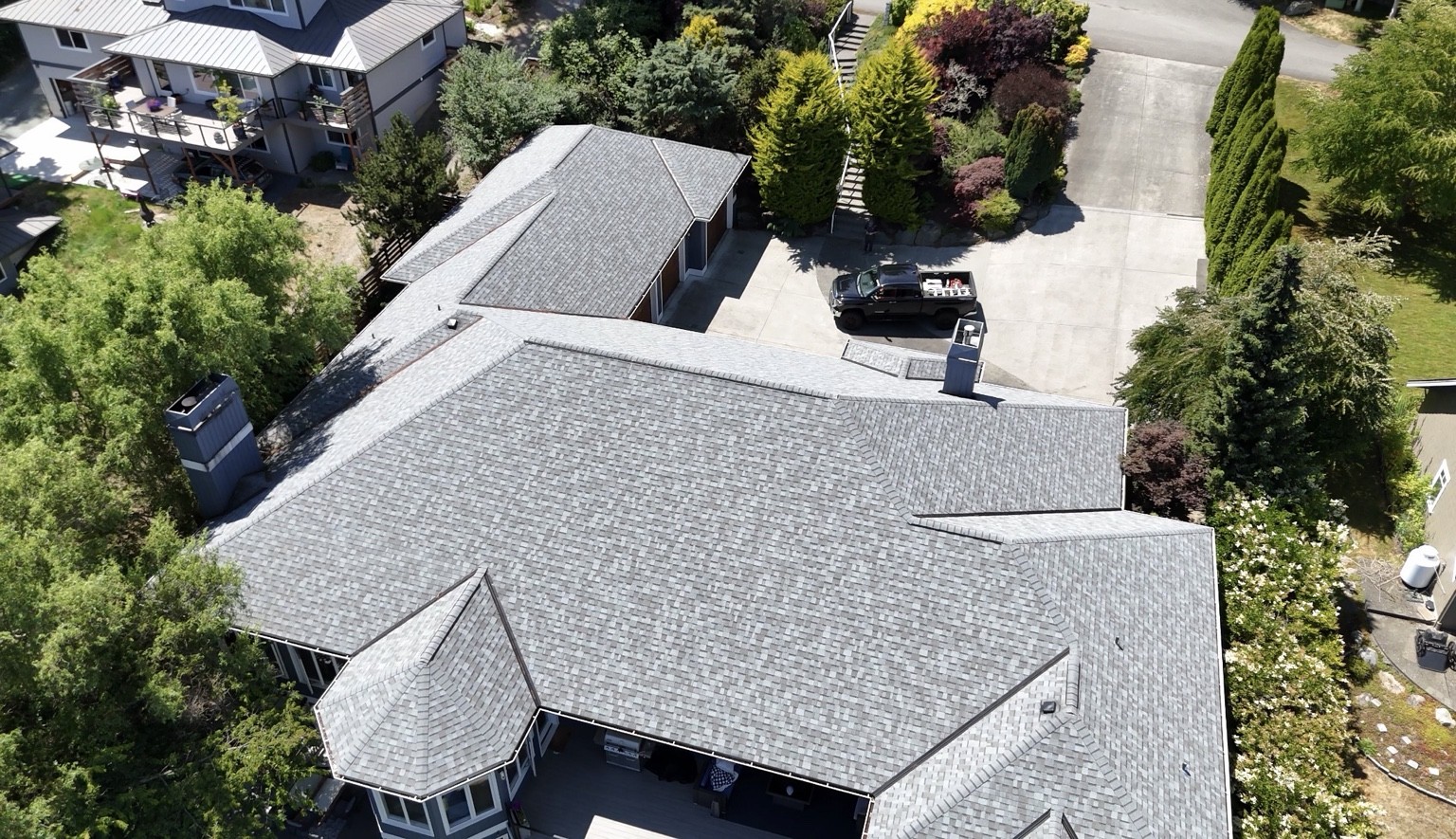 Aerial view of the Freeland home’s intersecting rooflines finished with Sierra Gray shingles