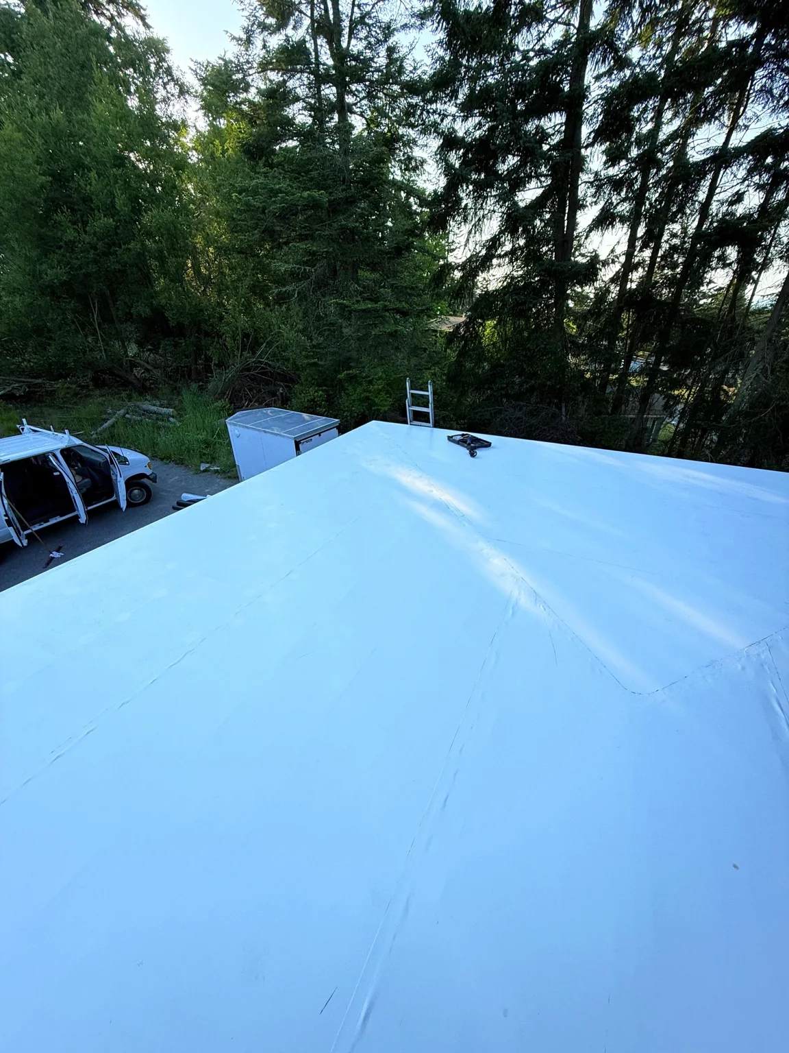 Completed white membrane roof with a raised center at an Oak Harbor home