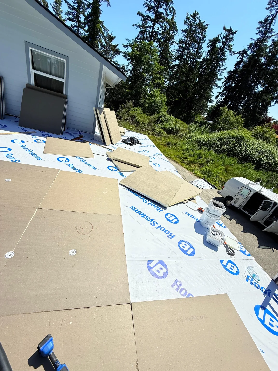 Insulation panels and roofing materials during the Oak Harbor flat roof drainage upgrade
