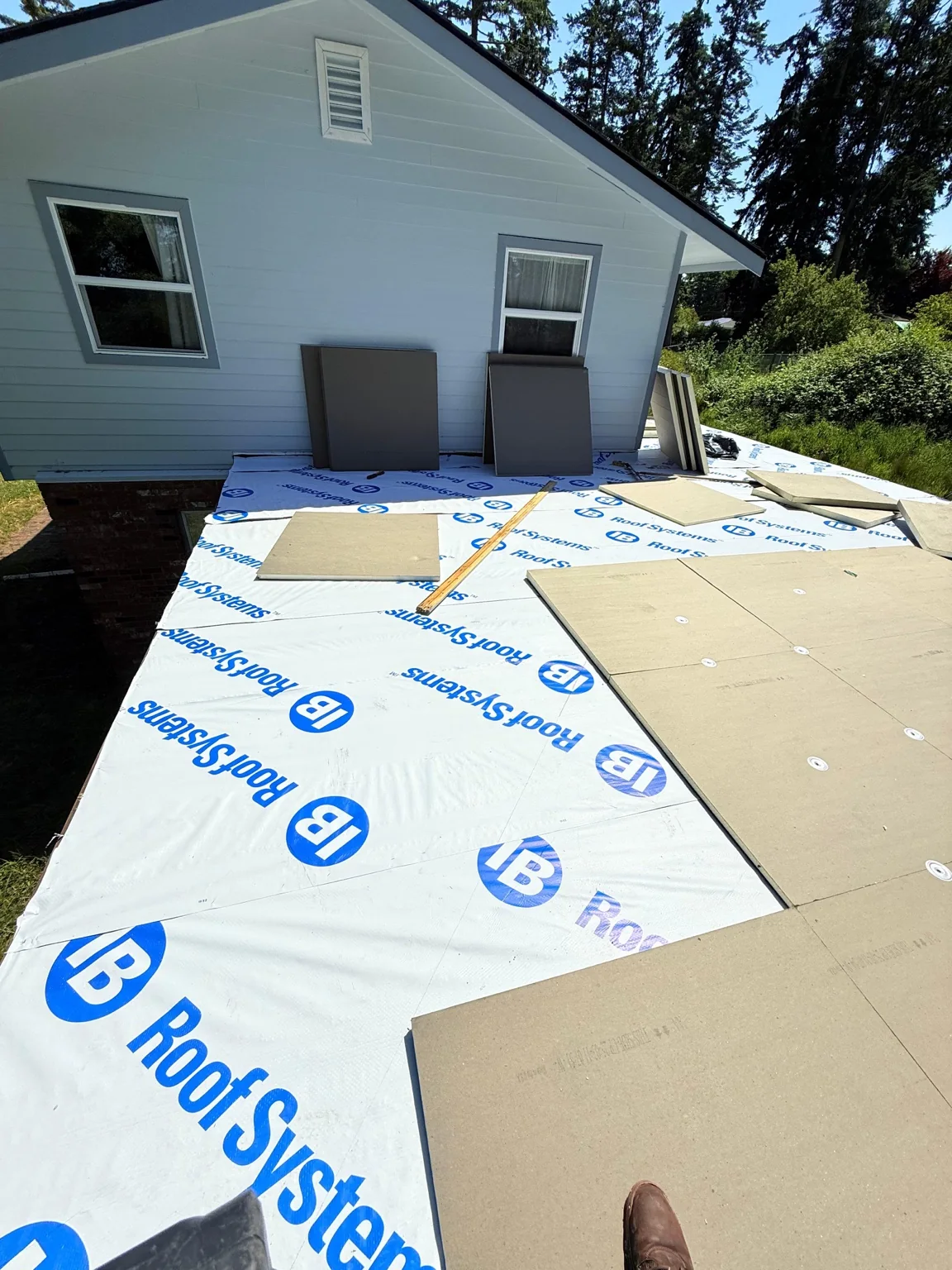Insulation installation in progress beside the home’s exterior wall