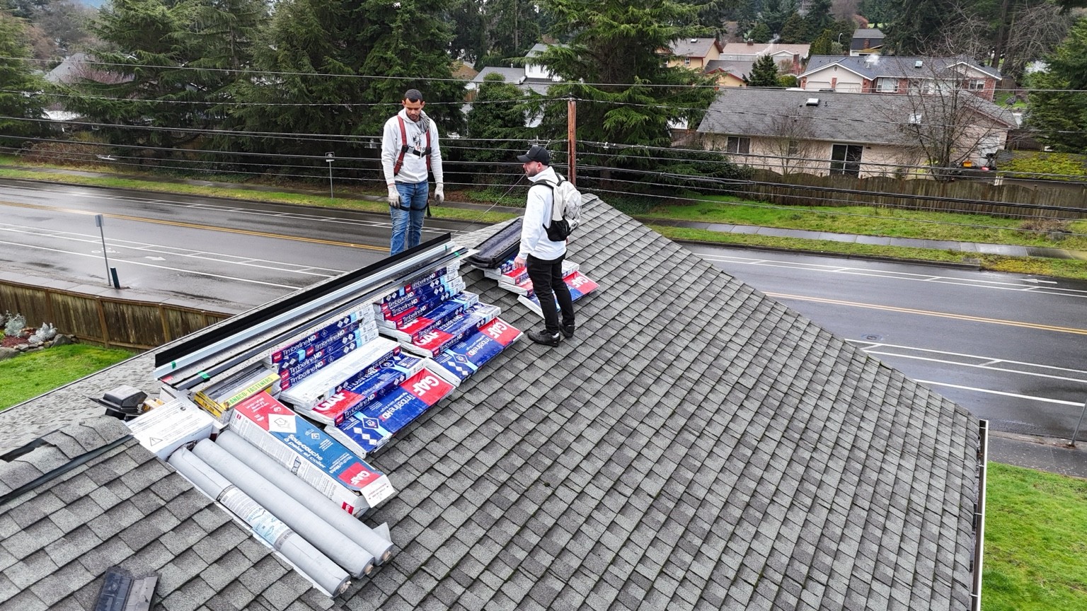 Crew members and GAF roofing materials staged on the existing roof before replacement