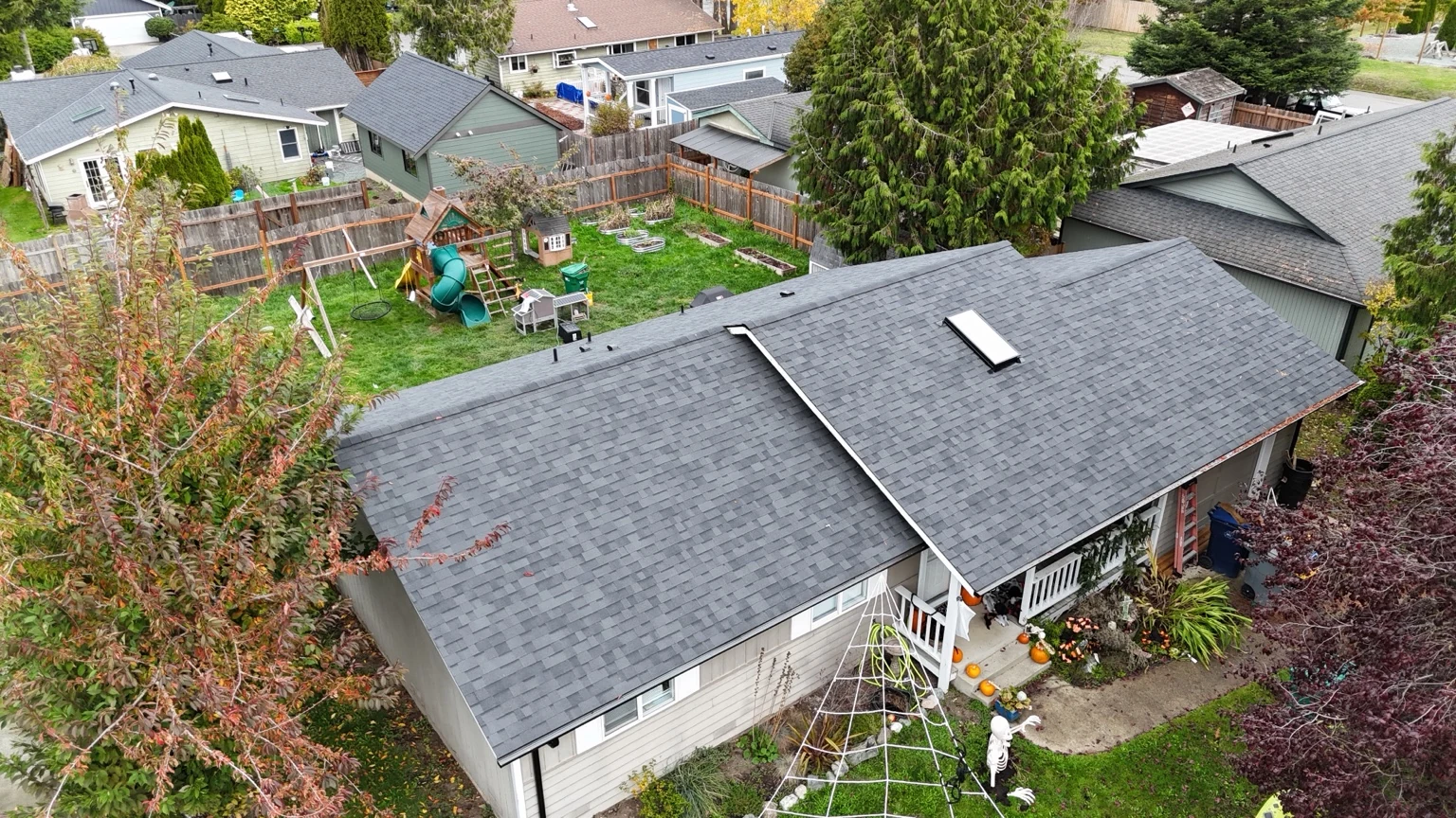 Front aerial view of the completed Malarkey Vista AR roof in Midnight Black and skylight on a Rockridge home in Anacortes