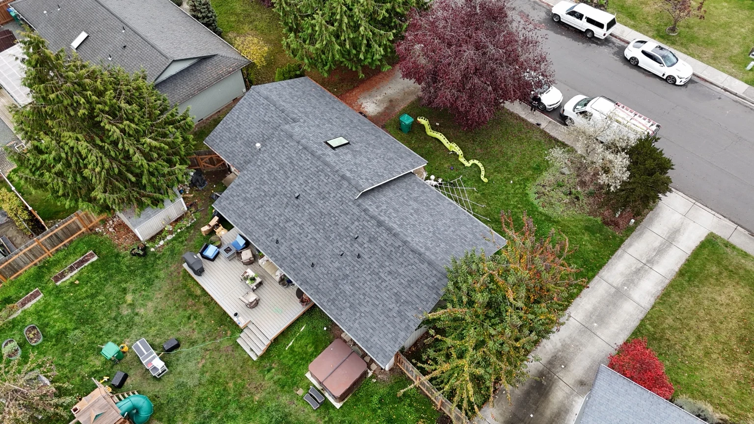 Angled aerial view of the completed Malarkey Vista AR roof with the backyard and street beyond