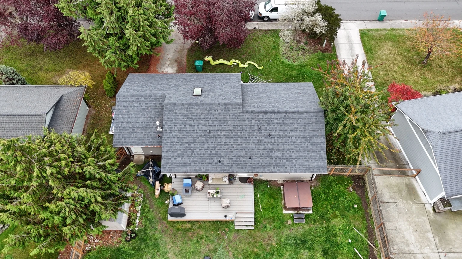 Rear overhead view of the new Midnight Black roof above the deck and backyard in Rockridge, Anacortes